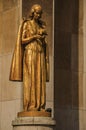 Statue of golden woman and dove in front of building at the Trocadero in Paris.